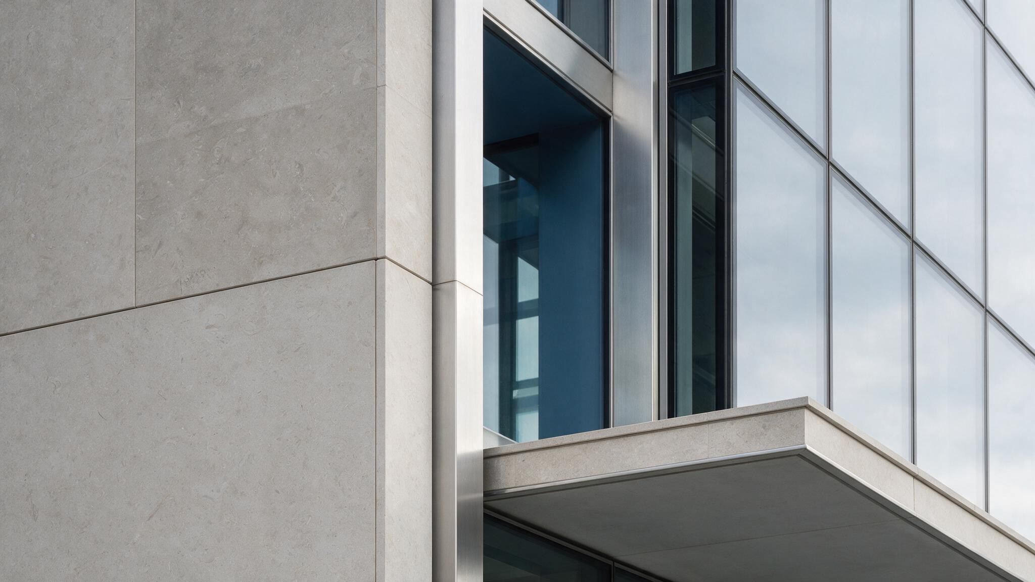 Stone cladding and glazing on a building corner
