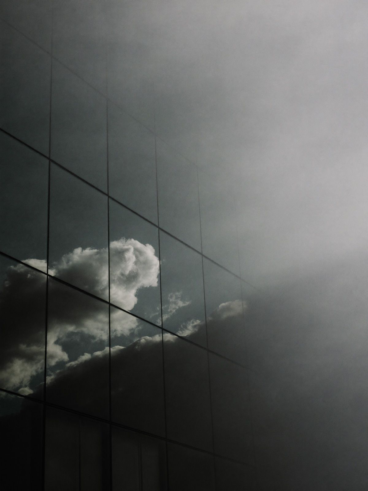 Glass curtain wall reflecting cloud