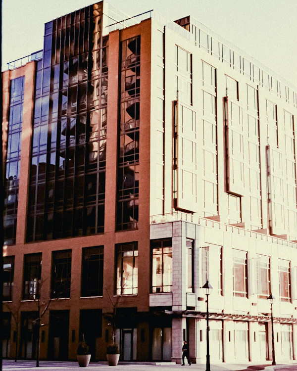 Modern office building with glass and brick facade at sunset